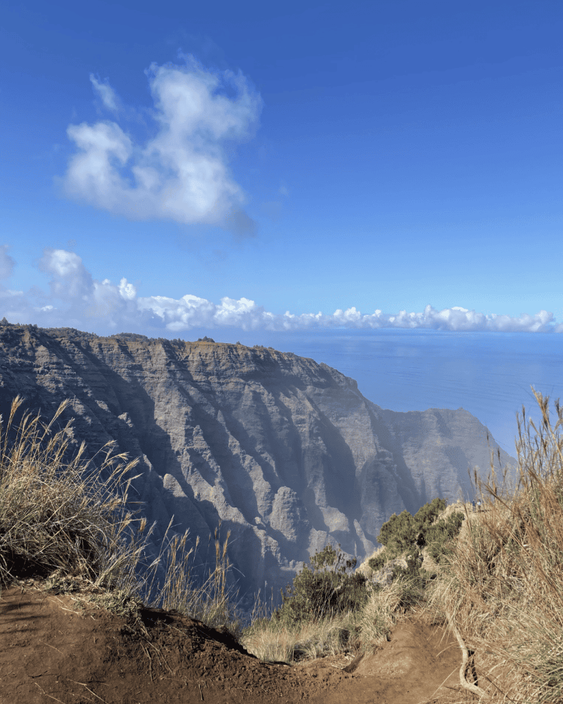 Hikers on the Kalalau Trail overlooking the Na Pali cliffs