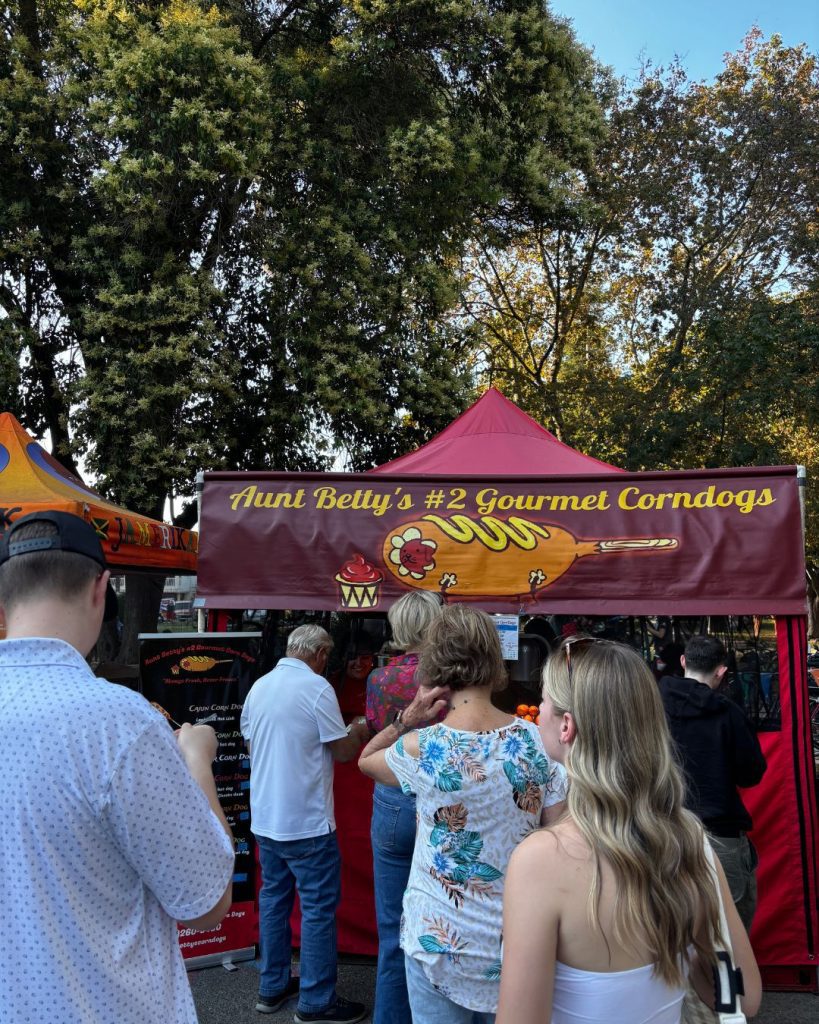 People queuing at a corndog stand at the Tuesday night market in Sonoma