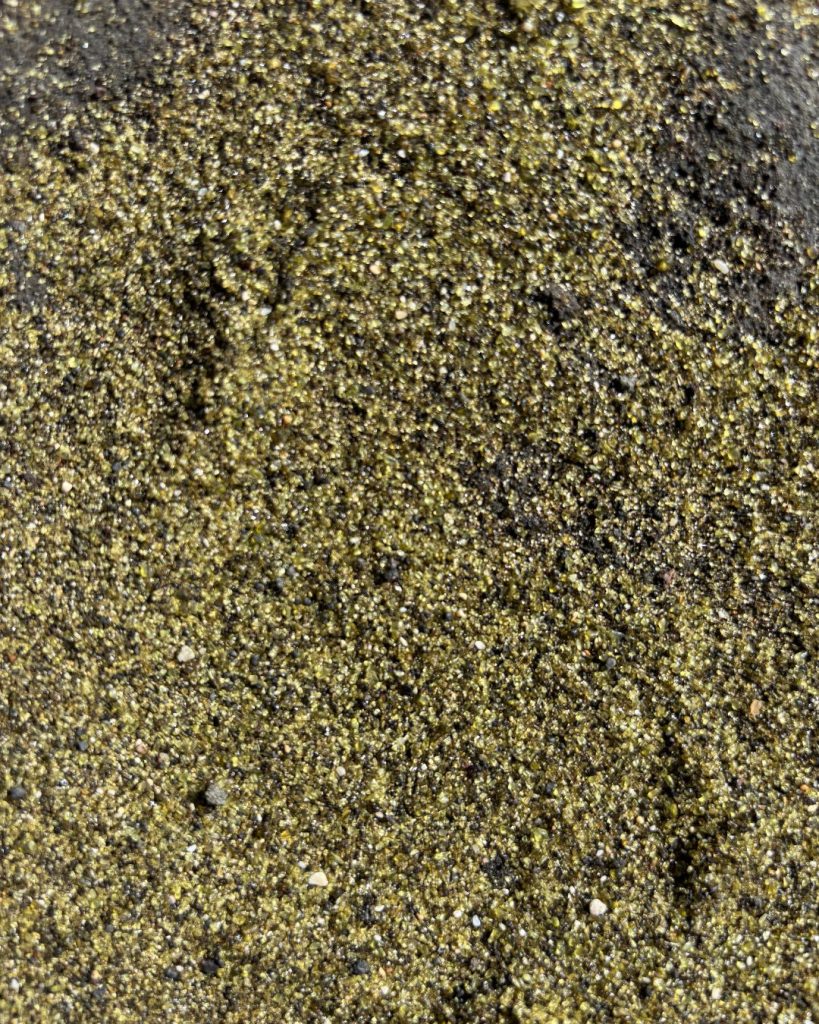 Close-up of the olive-green olivine sand grains at Papakolea Beach