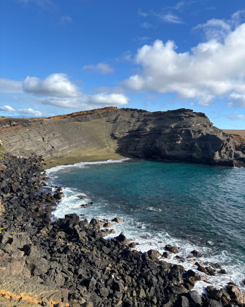 The green sand beach at Papakolea, curled inside an eroded cinder cone above turquoise water