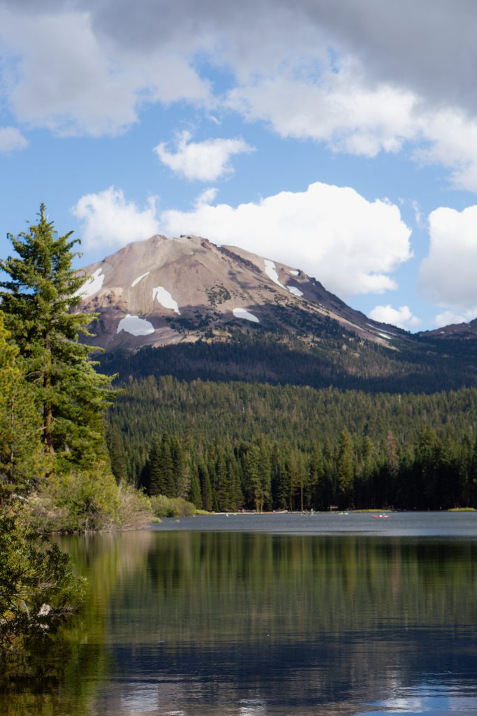 Lassen Peak rising above a forest lake in Lassen Volcanic National Park