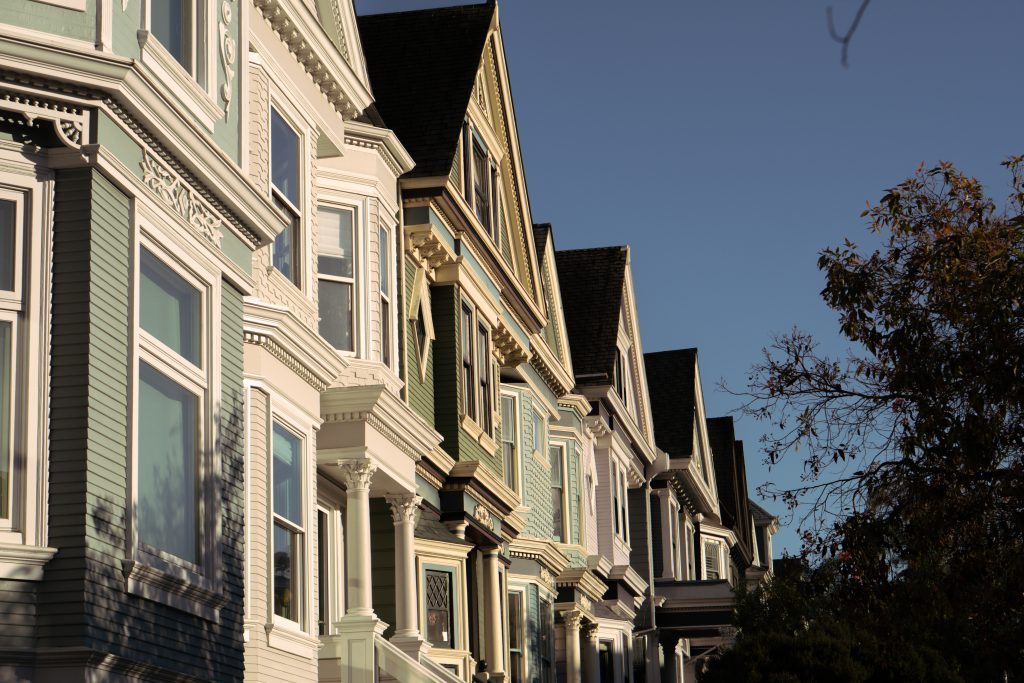 A row of Victorian houses along a sunny San Francisco street