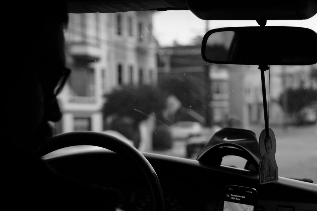 Black and white view from inside a car driving through the streets of San Francisco