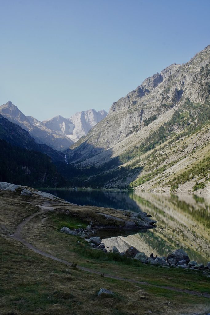 Turquoise mountain lake surrounded by steep rocky peaks in the Pyrenees
