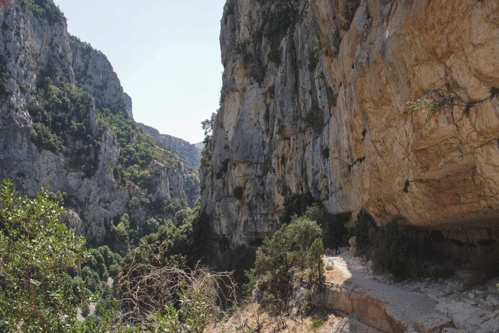 Sheer limestone walls of the Gorges du Verdon rising above the trail on the Sentier Blanc-Martel