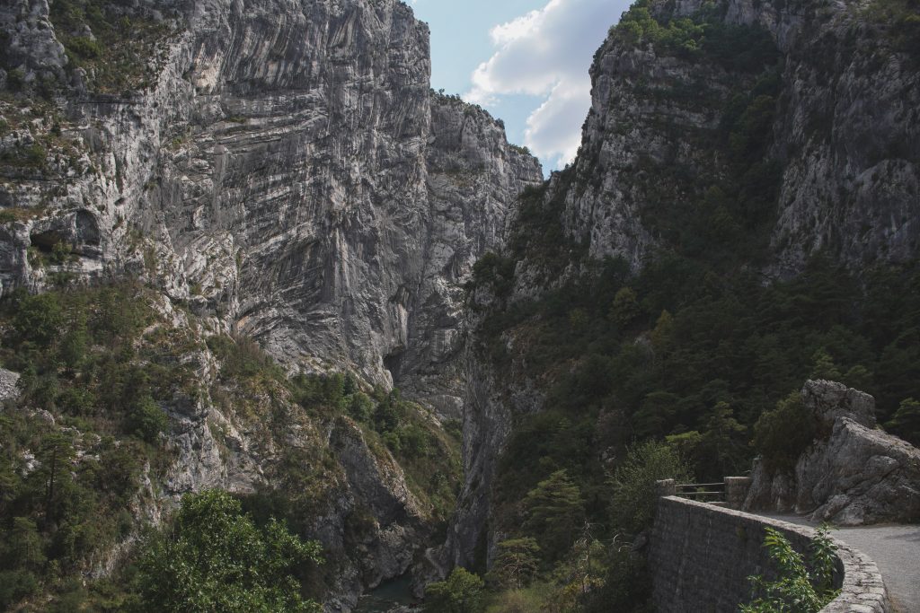 Limestone walls of the Gorges du Verdon with the road cut into the cliff below